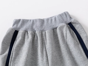 Macro detail of elastic ribbed waistband on boys heather grey knit sports pants