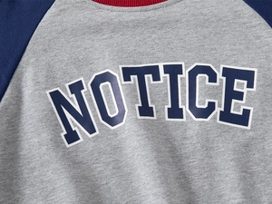 Close-up of kids sweatshirt featuring contrast rib neck and NOTICE letter print
