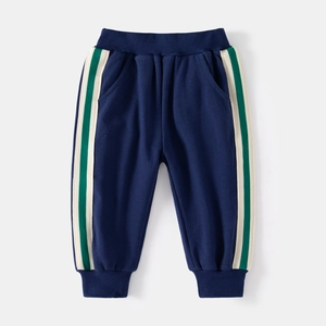 Detail of navy blue kids joggers featuring green and cream side stripes and ribbed cuffs