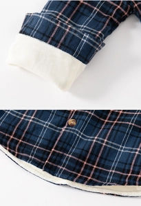 Détail d'une chemise à carreaux doublée polaire pour garçon avec velours et boutons ambre