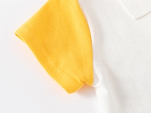 Macro detail of yellow and white piqué cotton fabric on kids short sleeve polo shirt