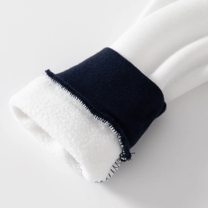 Thick white boys' baseball jacket with navy ribbed cuffs and warm fleece lining