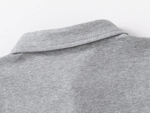 Detail of grey polo shirt collar and cotton fabric texture with double stitching