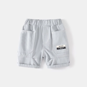 Detail of light gray boy's cotton shorts with elastic waist and large side pockets