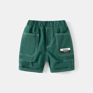 Detailed close-up of dark green boy's cargo shorts with elastic waist and woven label