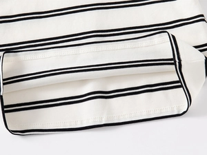 Macro view of the striped polo shirt hem with neat stitching and cotton knit texture