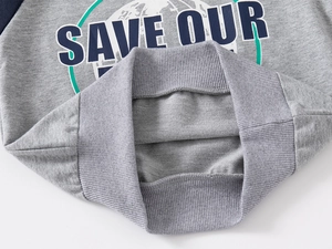 Detail of grey sweatshirt showing elastic ribbed hem and premium loopback cotton fabric