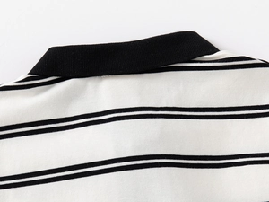 Detail of high-density cotton polo shirt featuring classic black and white stripes