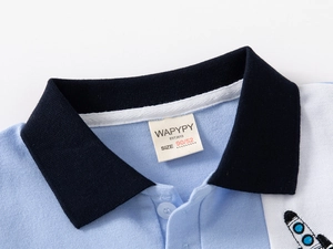 Detail of color-block polo collar and embroidered rocket on kids' cotton shirt