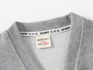 Detail of grey V-neck knit cardigan with SPORT branded ribbon and soft cotton texture