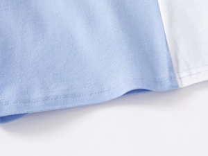 Detailed macro view of pique cotton fabric stitching on boys polo shirt hem
