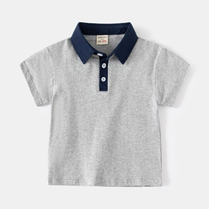 Detail of grey cotton kids polo shirt with navy collar and brand label on neck