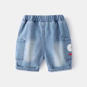 Detail of elastic waist and cartoon eye patch on light blue denim shorts for kids