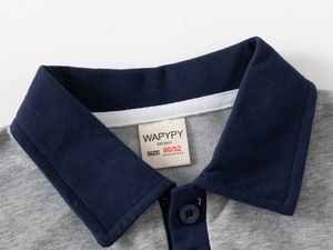 Close-up of kids polo sweatshirt featuring navy ribbed collar and grey knit fabric
