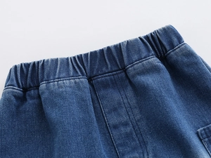 Detail of kids denim shorts featuring elastic waistband and durable twill fabric texture
