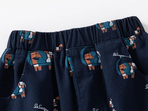 Detail of children's navy pants showing elastic waist and colorful elephant prints