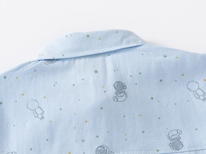 Detail of light blue cotton shirt collar with astronaut and star prints for boys