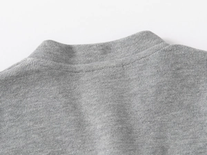 Close-up of the grey knitted sweatshirt neckline featuring smooth ribbed stitching texture