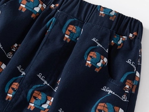 Detail of elastic waist and side pocket on kids shorts with colorful elephant print