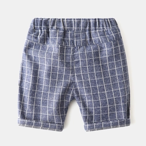 Detail of boys summer plaid shorts featuring elastic waistband and folded hem design