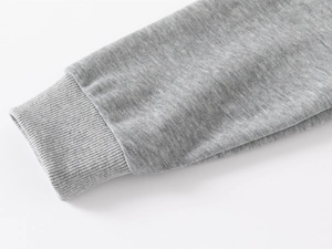 Close-up of the ribbed cuff on a grey knit long-sleeved shirt for kids