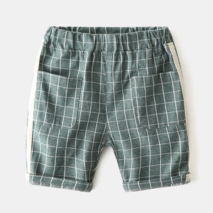 Detail of boys plaid cotton shorts featuring elastic waistband and side stripe accents