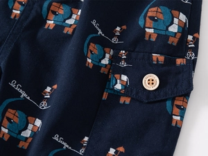 Detail of dark blue children shorts featuring elephant print and cargo pocket with button