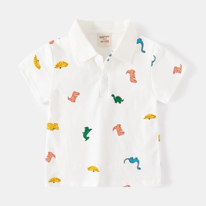 Detail view of children's white polo shirt featuring colorful dinosaur cartoon print patterns