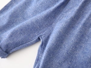 Detailed close-up of blue linen fabric texture and high-quality stitching on boys' shorts