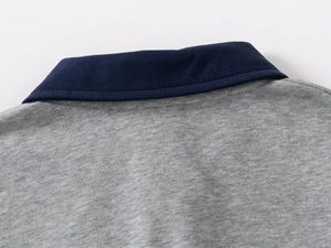 Detail of the navy blue polo collar and stitching on the heather grey knit sweatshirt