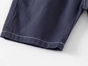 Detail shot of navy blue cotton shorts featuring premium double-stitched white seams