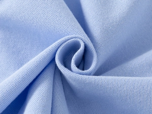 Close-up of light blue piqué cotton knit fabric texture with breathable honeycomb weave
