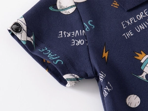 Close-up of navy piqué cotton polo shirt with rocket and planet space patterns
