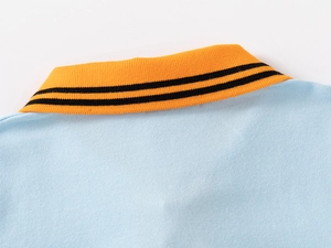 Close-up of baby boy polo shirt collar with sky blue knit fabric and yellow ribbed trim