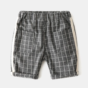 Detailed view of kids' grey checkered shorts featuring elastic waist and side stripes