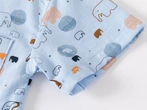 Detail of light blue short-sleeved kids shirt with cute elephant print and pocket