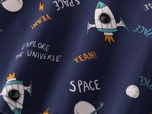 Close-up of navy blue twill fabric with cartoon space prints and planetary patterns