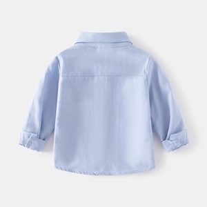 Detail view of boys' light blue shirt back yoke with high-quality cotton texture