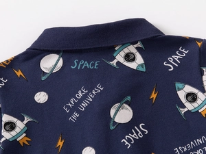 Detailed macro shot of navy piqué cotton fabric featuring colorful space exploration prints
