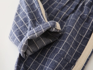 Detail shot of blue windowpane check kids shorts with side tape and rolled hem stitching