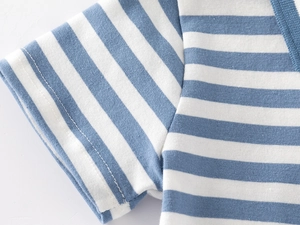 Detailed close-up of blue and white striped cotton polo shirt cuff showing fine stitching