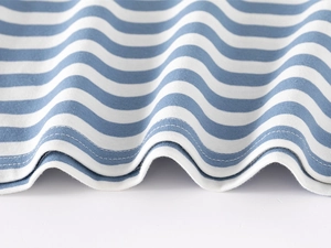 Detail of the blue and white striped cotton polo shirt hem with double-needle stitching