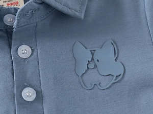 Detail of blue cotton polo shirt with a French Bulldog silhouette and three-button collar