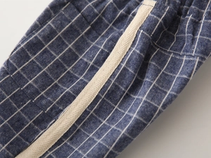 Macro view of blue checkered cotton shorts with elastic waistband and side twill tape