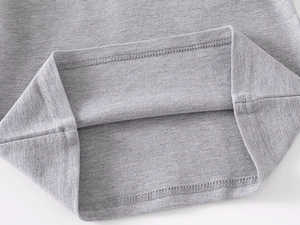 Close-up of double-needle hem and fine knit texture on grey cotton polo shirt
