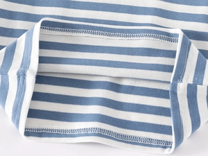 Close-up of double-needle hem stitching on blue and white striped cotton polo shirt