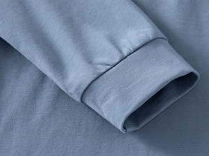 Detail of ribbed cuffs on blue long sleeve cotton polo shirt for boys with fine stitching