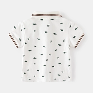 White short-sleeved kids Polo shirt with all-over green dinosaur and palm tree patterns