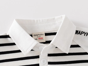 Macro detail of kids striped polo shirt neckline with brand label and button closure