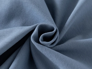 Close-up of soft navy blue knitted cotton fabric texture for children long sleeve polo shirts